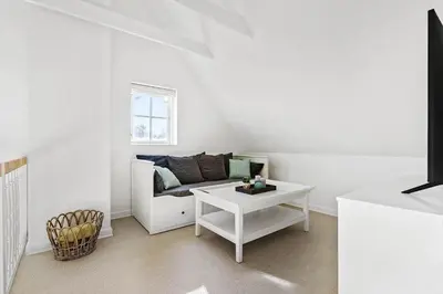 a white living room with a couch and a table at BL1443-Blokhus-Ferren-Syd-46 in Blokhus