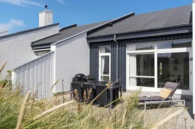 a gray house with a black roof at BL1480-Blokhus-Ferren-51 in Blokhus
