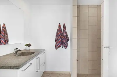 a bathroom with a sink and a shower at BL1480-Blokhus-Ferren-51 in Blokhus