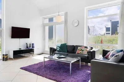 a living room with a couch and a table at BL1480-Blokhus-Ferren-51 in Blokhus