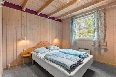 a bedroom with a bed in a room with a window at BL1786-Saltum-Ornebjergvej-22 in Saltum