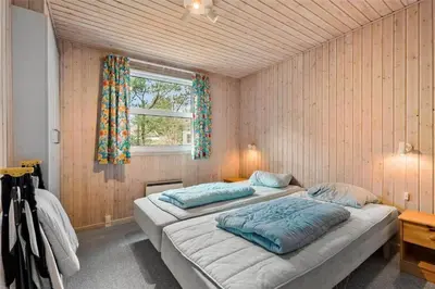 a bedroom with two beds and a window at BL1786-Saltum-Ornebjergvej-22 in Saltum