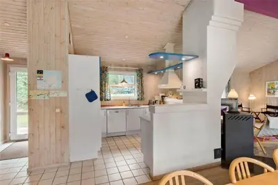 a kitchen with a white refrigerator and a table at BL1786-Saltum-Ornebjergvej-22 in Saltum