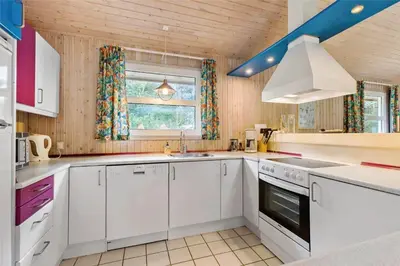 a kitchen with white cabinets and a sink and a window at BL1786-Saltum-Ornebjergvej-22 in Saltum