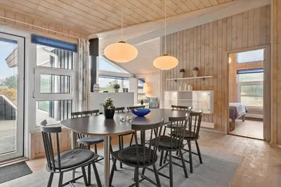 a kitchen and dining room with a table and chairs at BL295-Saltum-Graabakken-2 in Saltum