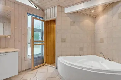 a large bathroom with a tub and a window at BL295-Saltum-Graabakken-2 in Saltum