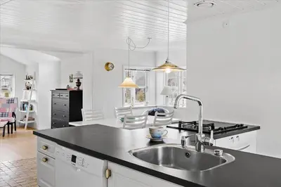 a kitchen with a sink and a counter top at BL395-Blokhus-Maren-Hjortelsvej-4 in Blokhus