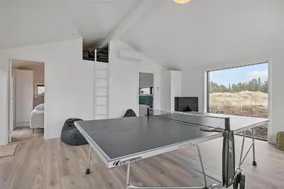 a living room with a ping pong table in it at BL1740-Blokhus-Axel-P-Jensenvej-19 in Blokhus