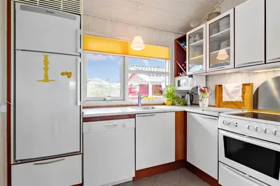a kitchen with white appliances and a window at BL330-Blokhus-Lyngvej-2 in Blokhus