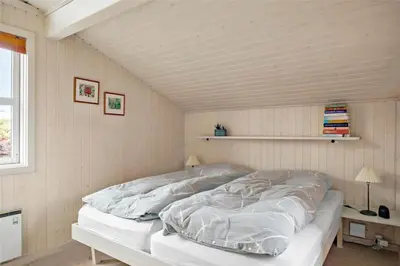 a white bed in a room with a ceiling at BL330-Blokhus-Lyngvej-2 in Blokhus