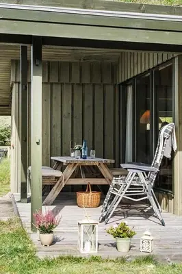 a chair and a picnic table on a porch at BL1308-Saltum-Kordalsvej-124 in Saltum