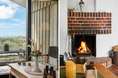 a living room with a brick fireplace and a table with a fire place at BL1308-Saltum-Kordalsvej-124 in Saltum