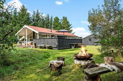 a fire pit in a yard in front of a house at BL1338-Pandrup-Lunekrogen-10 in Pandrup