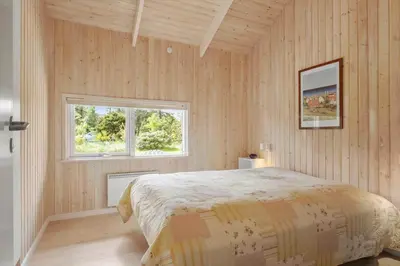 a bedroom with a bed and a window at BL279-Pandrup-Rodhusparken-71 in Pandrup