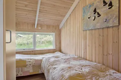 a bedroom with a bed in a room with a window at BL279-Pandrup-Rodhusparken-71 in Pandrup