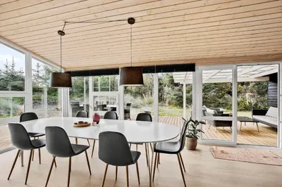 a dining room with a white table and chairs at BL1774-Blokhus-Ronliensvej-11 in Blokhus
