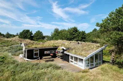 a house with a grass roof with a deck at BL199-Saltum-Daadyrvej-22 in Saltum