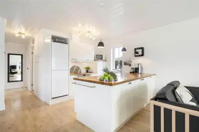 a kitchen with white cabinets and a counter top at BL475-Blokhus-Peder-Madsensvej-21 in Blokhus