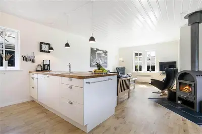 a kitchen with white cabinets and a stove at BL475-Blokhus-Peder-Madsensvej-21 in Blokhus