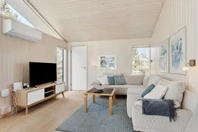 a living room with a couch and a tv at BL1461-Saltum-Kvansletten-29 in Saltum