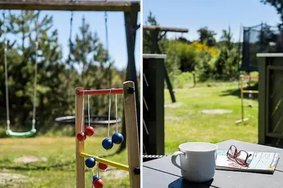 a table with a cup of coffee and a ball at BL1366-Blokhus-Berberisvej-56 in Blokhus