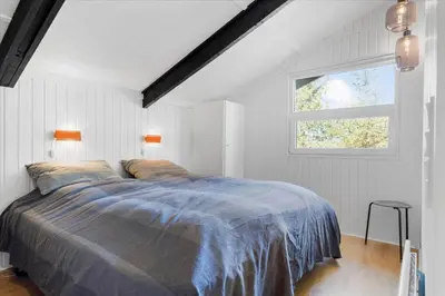 a bedroom with a bed and a window at BL794-Pandrup-Hunetorp-Klitvej-113 in Pandrup