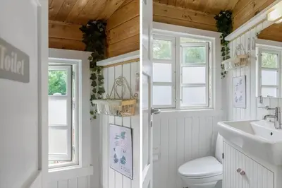 a bathroom with a toilet and a sink and windows at BL1694-Saltum-Klaus-Bjergsvej-8 in Saltum