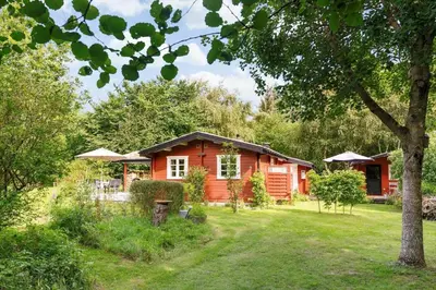 a log cabin in the middle of a yard at BL1694-Saltum-Klaus-Bjergsvej-8 in Saltum