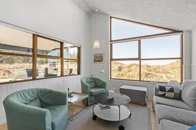 a living room with two chairs and a table at BL980-Saltum-Faarup-Klitvej-46 in Saltum