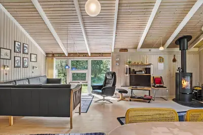a living room with a couch and a fireplace at BL565-Pandrup-Lunekrogen-22 in Pandrup