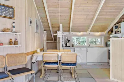a kitchen with a table and chairs in a room at BL565-Pandrup-Lunekrogen-22 in Pandrup