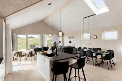 a kitchen and dining room with a table and chairs at BL1481-Saltum-Kommenvej-1 in Saltum