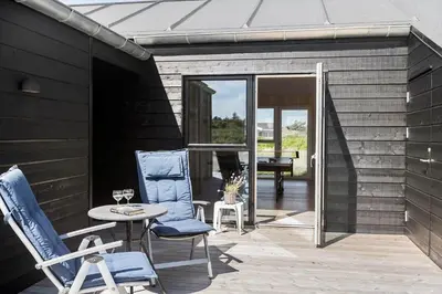 a patio with chairs and a table and a piano at BL1481-Saltum-Kommenvej-1 in Saltum