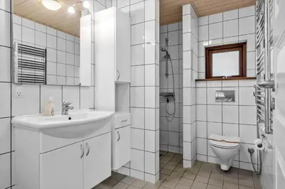 a white bathroom with a sink and a toilet at BL308-Saltum-Laustvej-24 in Saltum