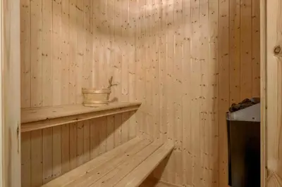 a room with a wooden wall with a wooden shelf at BL308-Saltum-Laustvej-24 in Saltum