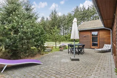a patio with a table and an umbrella at BL308-Saltum-Laustvej-24 in Saltum