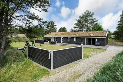 a house with a fence in front of it at BL1110-Blokhus-Bloksbjerg-7 in Blokhus