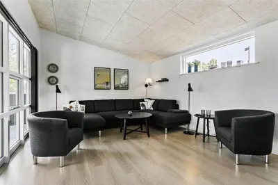 a living room with a couch and chairs and a table at BL1110-Blokhus-Bloksbjerg-7 in Blokhus