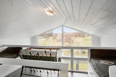 a room with a table and chairs and a large window at BL106-Saltum-Tolhoj-2 in Saltum