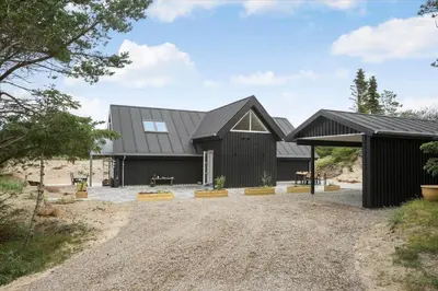 a black barn with a black roof at BL1506-Saltum-Kronhjortvej-15 in Saltum