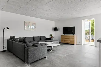a living room with a couch and a tv at BL1506-Saltum-Kronhjortvej-15 in Saltum