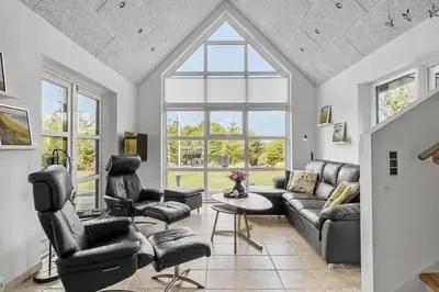 a living room with a couch and chairs and a table at BL1509-Blokhus-Stromsvej-7 in Blokhus