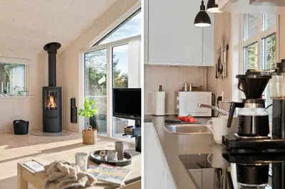 a kitchen with a stove and a kitchen with a fireplace at BL387-Blokhus-Berberisvej-51 in Blokhus