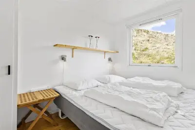 a white bedroom with a bed and a window at BL808-Pandrup-Hare-hop-5 in Pandrup