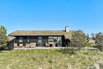 a black house with a grass roof at BL1408-Pandrup-Hunetorp-Klitvej-243 in Pandrup