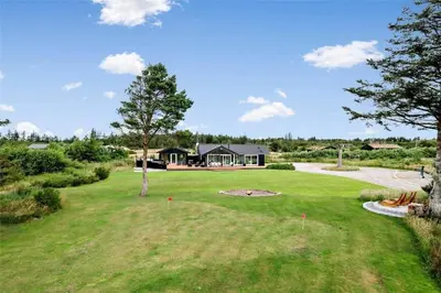 a yard of a home with a tree in the middle at BL425-Saltum-Tippen-22 in Saltum
