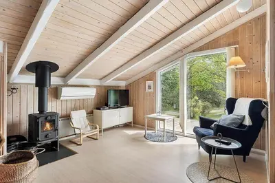 a living room with a couch and a fireplace at BL1052-Blokhus-Berberisvej-22 in Blokhus