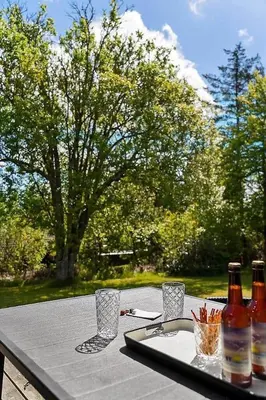 a table with a tray with bottles and glasses on it at BL1052-Blokhus-Berberisvej-22 in Blokhus