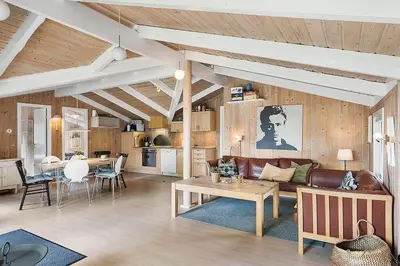 a living room with a couch and a table at BL1052-Blokhus-Berberisvej-22 in Blokhus