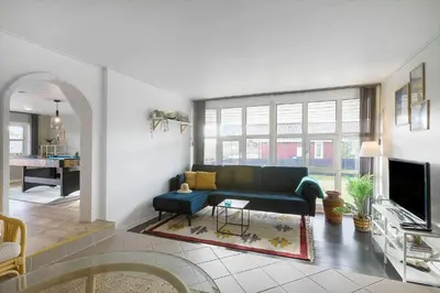a living room with a couch and a tv at BL1498-Blokhus-Bag-Somaerket-22 in Blokhus